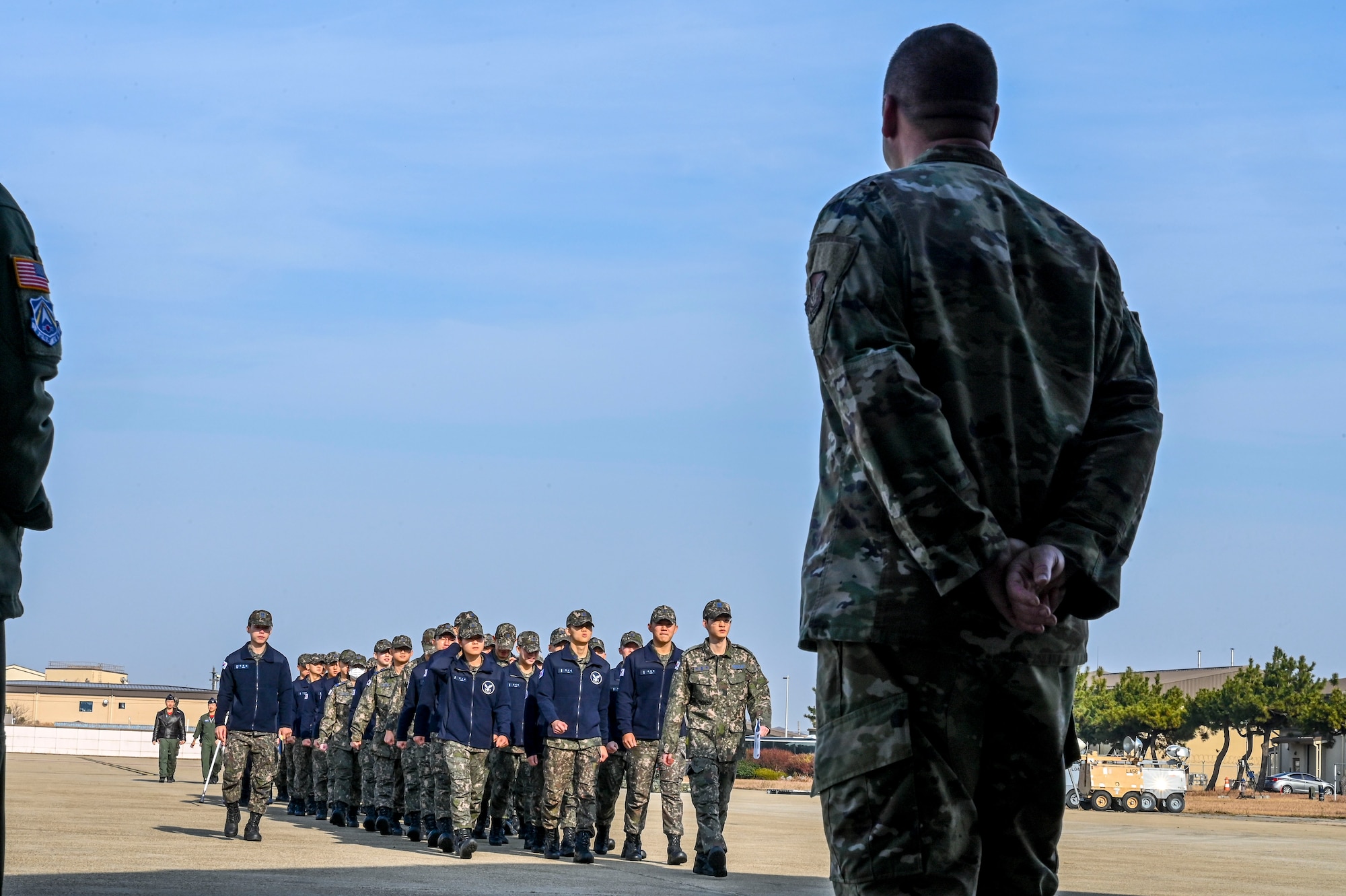 A man watches a group of people.
