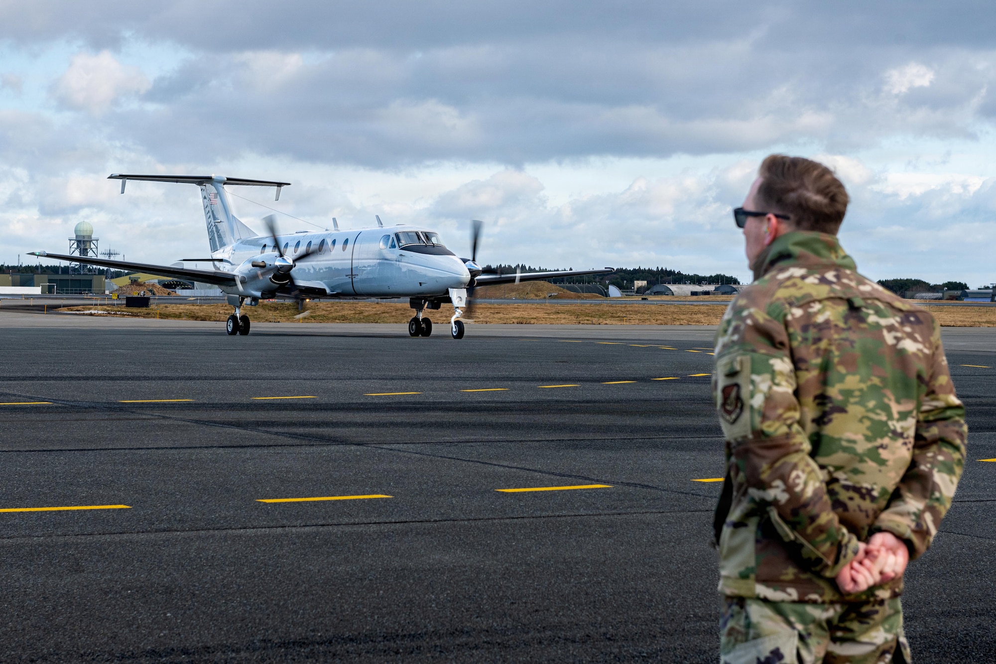 U.S. Air Force Col. Paul Davidson, 35th Fighter Wing (FW) commander, stands by as Lt. Gen. Stephen Jost, U.S. Forces Japan and Fifth Air Force commander, arrives in a C-12 Huron.