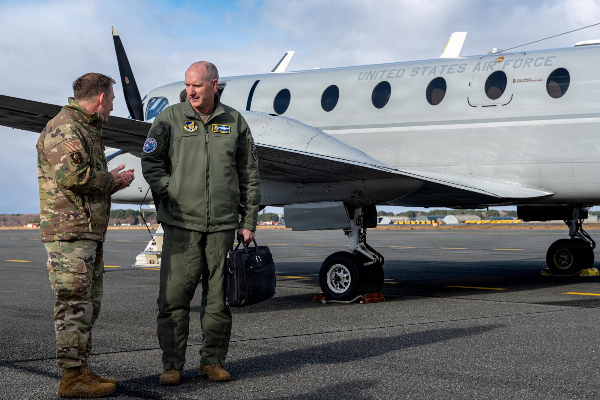 U.S. Air Force Col. Paul Davidson, left, 35th Fighter Wing (FW) commander, speaks with Lt. Gen. Stephen Jost, U.S. Forces Japan and Fifth Air Force commander, in front of a C-12 Huron.