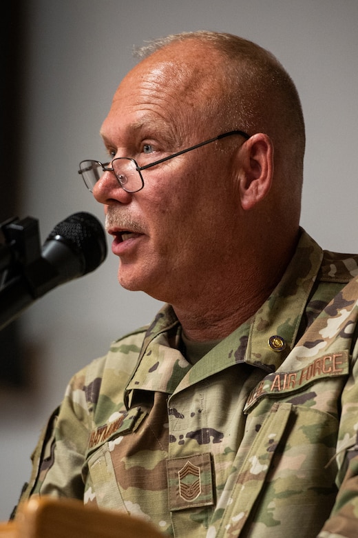 Chief Master Sgt. Krome A. Raymond, senior enlisted leader for the 123rd Mission Support Group, speaks to an audience of fellow Airmen, family and friends during his retirement ceremony at the Kentucky Air National Guard Base in Louisville, Ky., Sept. 7, 2025. Raymond served 22 years in both the active-duty Air Force and Kentucky Air Guard during three periods of enlistment spread over 38 years. (U.S. Air National Guard photo by Senior Airman Annaliese Billings)