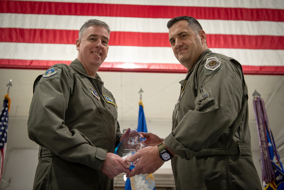 Col. Matthew Quenichet (right), commander of the 123rd Airlift Wing, accepts the wing’s sixth Curtis N. “Rusty” Metcalf Trophy from Brig. Gen. Bruce Bancroft, Kentucky’s assistant adjutant general for Air, during a ceremony at the Kentucky Air National Guard Base in Louisville, Ky., Dec. 14, 2025. The Metcalf trophy honors the best airlift or air refueling wing in the Air National Guard each year. (U.S. Air National Guard photo by Master Sgt. Joshua Horton)