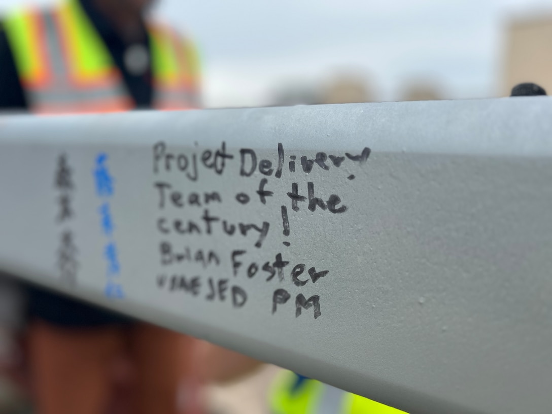 A written message by a U.S. Army Corps of Engineers – Japan Engineer District (USACE JED) team member is photographed on the last structural beam for a currently under-construction Corrosion Control Hangar on Yokota Air Base, Japan, October, 3rd 2025.  Awarded in September 2023 to Gilbane Japan GK, the project represents an investment of approximately $98.45 million in Yokota’s long-term mission readiness, and during the initial phases of the project, 155,000 manhours elapsed without incident, marking a significant safety milestone. Courtesy photo provided by Gilbane Japan.