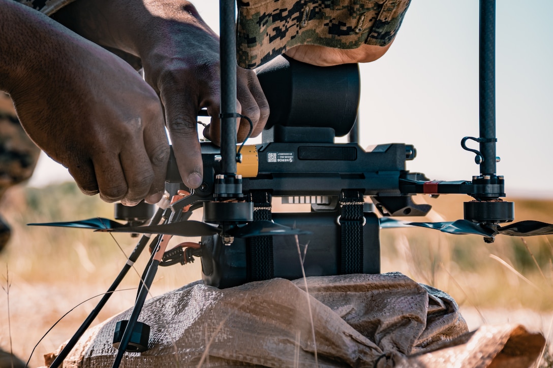 U.S. Marines with III Marine Expeditionary Force load a notional payload on a drone during the Marine Corps Attack Drone Competition on Camp Schwab, Okinawa, Japan, Dec. 9, 2025.