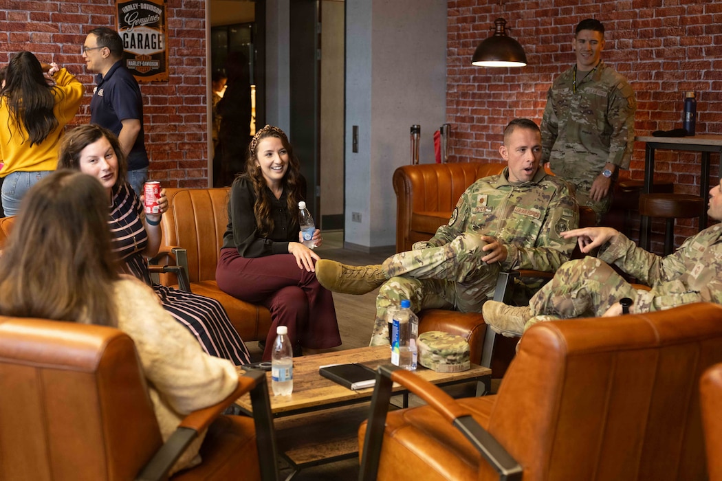 U.S. Air Force Airmen and members of the Spangdahlem community converse during the opening of the Brick House at Spangdahlem Air Base, Germany, Sept. 30, 2025. The Brick House provides an accessible setting for Airmen and civilians to gather and build connections.  (U.S. Air Force photo by Senior Airman Darius Frazier)