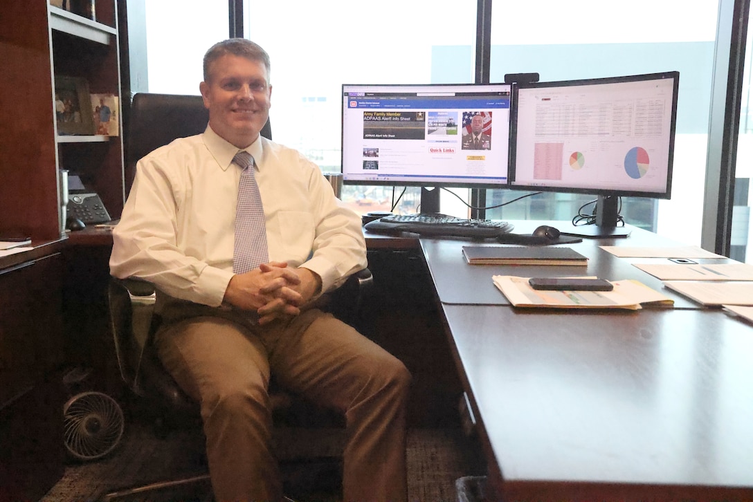 Man sitting at a desk.