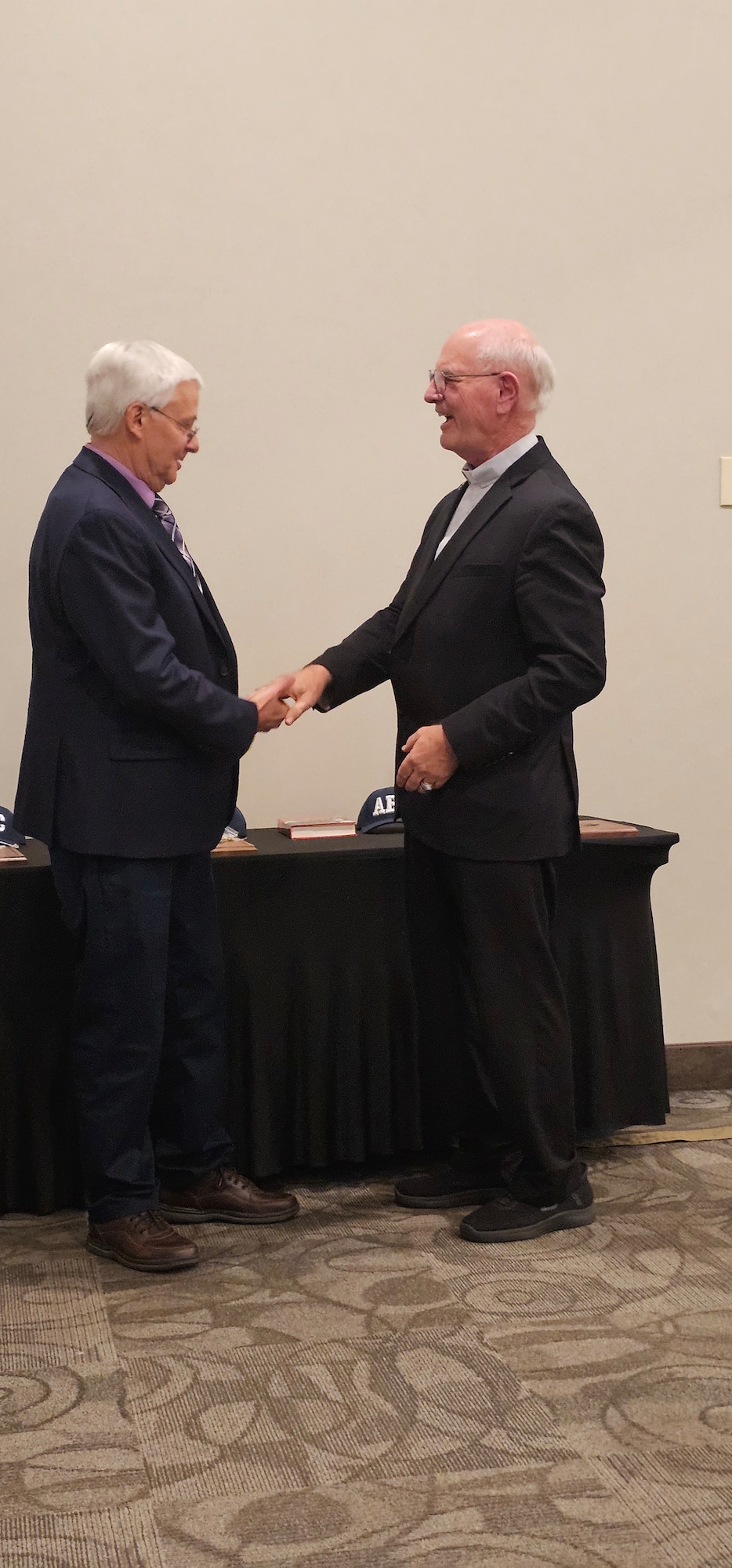 Bill Phillips, left, shakes hands with retired Air Force Gen. Mike Wiedemer, chair of the Arnold Engineering Development Complex Fellows Program, following his induction as an AEDC Fellow during the recent Arnold Community Council annual banquet. Phillips, selected as an AEDC Technical Fellow, was recognized for his design, development and implementation of spectral models and codes, advancing the state-of-the-art in signature modeling for both AEDC and the nation. Phillips was one of three Fellows inducted during the banquet. The AEDC Fellows program, established in 1989, recognizes AEDC personnel who have made substantial and exceptionally distinguished contributions to the nation’s aerospace ground testing capability. (Courtesy photo)