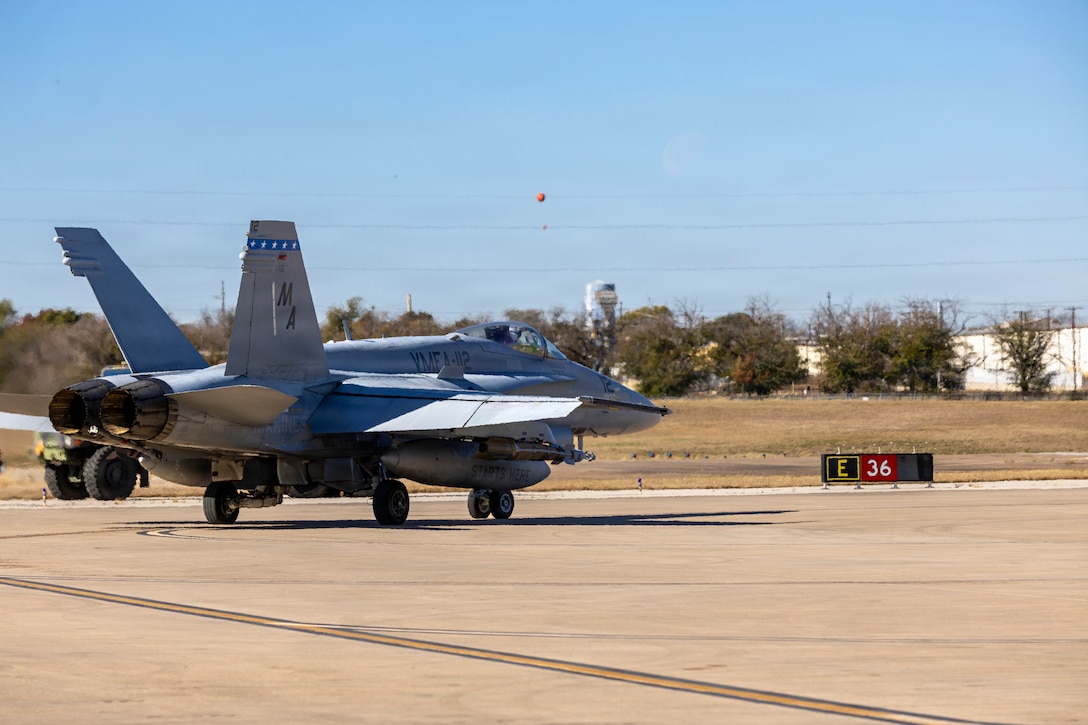 A U.S. Marine Corps F/A-18C Hornet aircraft with Marine Fighter Attack Squadron (VMFA) 112, Marine Aircraft Group 41, 4th Marine Aircraft Wing, taxis in preparation for take-off to conduct close air support training at Naval Air Station Joint Reserve Base Fort Worth, Texas, Dec. 9, 2025. The training serves to increase proficiency, validate ordinance handling procedures, and support joint fire support elements. (U.S. Marine Corps photo by Staff Sgt. Ethan M. LeBlanc)