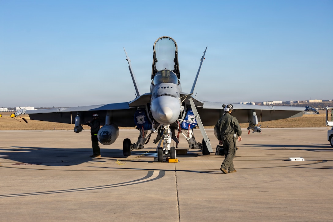 A U.S. Marine Corps F/A-18C Hornet aircraft receives final checks from ordinance Marines with Marine Fighter Attack Squadron (VMFA) 112, Marine Aircraft Group 41, 4th Marine Aircraft Wing, in preparation to conduct close air support training at Naval Air Station Joint Reserve Base Fort Worth, Texas, Dec. 9, 2025. The training serves to increase proficiency, validate ordinance handling procedures, and support joint fire support elements. (U.S. Marine Corps photo by Staff Sgt. Ethan M. LeBlanc)