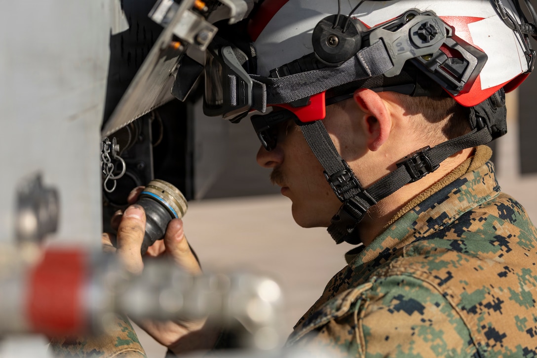 U.S. Marine Corps Cpl. Jared Roth, an aircraft ordnance technician with Marine Fighter Attack Squadron (VMFA) 112, Marine Aircraft Group 41, 4th Marine Aircraft Wing, conducts final checks on an F/A-18C Hornet aircraft in preparation for close air support training at Naval Air Station Joint Reserve Base Fort Worth, Texas, Dec. 9, 2025. The training serves to increase proficiency, validate ordinance handling procedures, and support joint fire support elements. (U.S. Marine Corps photo by Staff Sgt. Ethan M. LeBlanc)