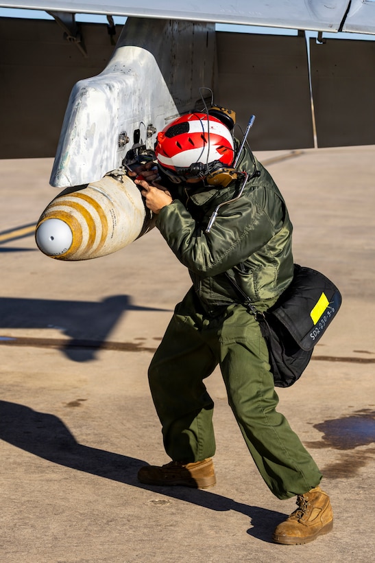 U.S. Marine Corps Cpl. Elijah Miller, an aircraft ordnance technician with Marine Fighter Attack Squadron (VMFA) 112, Marine Aircraft Group 41, 4th Marine Aircraft Wing, conducts final checks on an F/A-18C Hornet aircraft in preparation for close air support training at Naval Air Station Joint Reserve Base Fort Worth, Texas, Dec. 9, 2025. The training serves to increase proficiency, validate ordinance handling procedures, and support joint fire support elements. (U.S. Marine Corps photo by Staff Sgt. Ethan M. LeBlanc)