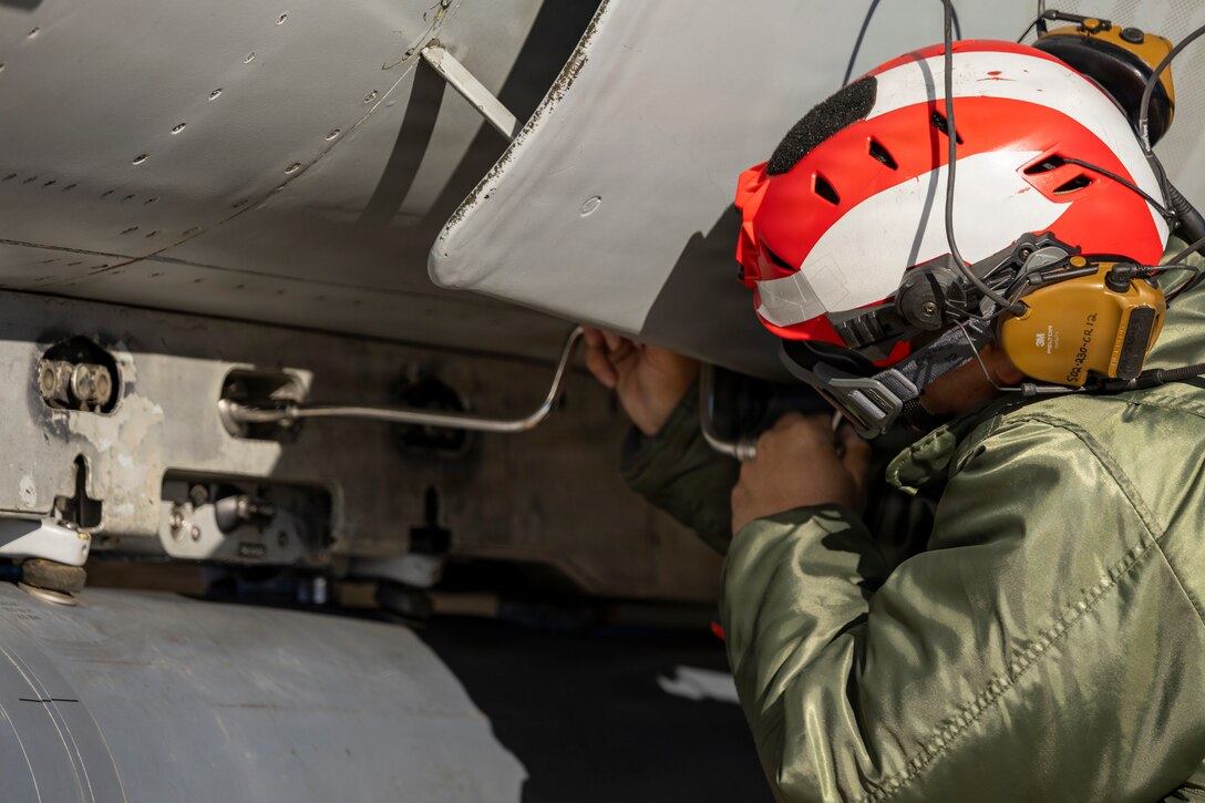 U.S. Marine Corps Cpl. Elijah Miller, an aircraft ordnance technician with Marine Fighter Attack Squadron (VMFA) 112, Marine Aircraft Group 41, 4th Marine Aircraft Wing, conducts final checks on an F/A-18C Hornet aircraft in preparation for close air support training at Naval Air Station Joint Reserve Base Fort Worth, Texas, Dec. 9, 2025. The training serves to increase proficiency, validate ordinance handling procedures, and support joint fire support elements. (U.S. Marine Corps photo by Staff Sgt. Ethan M. LeBlanc)