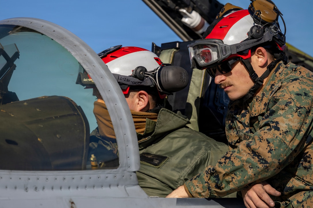 U.S. Marine Corps Cpl. Jared Roth, right, and Lance Cpl. William Grigry, left, aircraft ordnance technicians with Marine Fighter Attack Squadron (VMFA) 112, Marine Aircraft Group 41, 4th Marine Aircraft Wing, conduct final checks on an F/A-18C Hornet aircraft in preparation for close air support training at Naval Air Station Joint Reserve Base Fort Worth, Texas, Dec. 9, 2025. The training serves to increase proficiency, validate ordinance handling procedures, and support joint fire support elements. (U.S. Marine Corps photo by Staff Sgt. Ethan M. LeBlanc)