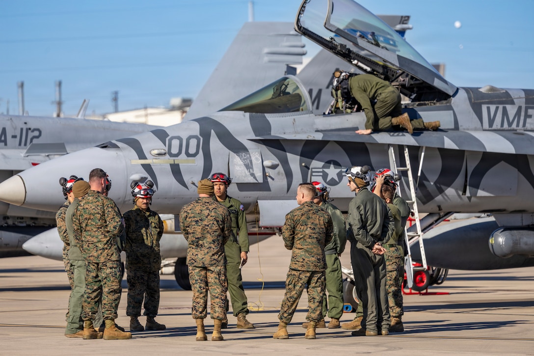 U.S. Marines with Marine Fighter Attack Squadron (VMFA) 112, Marine Aircraft Group 41, 4th Marine Aircraft Wing, hold a briefing in preparation for close air support training at Naval Air Station Joint Reserve Base Fort Worth, Texas, Dec. 9, 2025. The training serves to increase proficiency, validate ordinance handling procedures, and support joint fire support elements. (U.S. Marine Corps photo by Staff Sgt. Ethan M. LeBlanc)