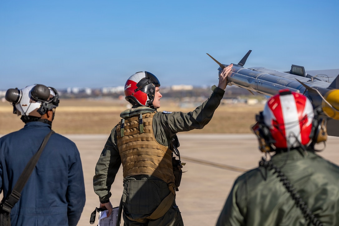 U.S. Marines with Marine Fighter Attack Squadron (VMFA) 112, Marine Aircraft Group 41, 4th Marine Aircraft Wing, conduct final checks on an F/A-18C Hornet aircraft in preparation for close air support training at Naval Air Station Joint Reserve Base Fort Worth, Texas, Dec. 9, 2025. The training serves to increase proficiency, validate ordinance handling procedures, and support joint fire support elements. (U.S. Marine Corps photo by Staff Sgt. Ethan M. LeBlanc)