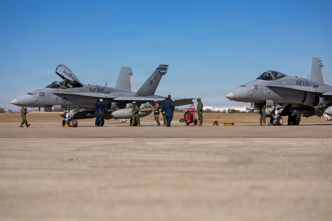 U.S. Marine Corps F/A-18C Hornet aircrafts with Marine Fighter Attack Squadron (VMFA) 112, Marine Aircraft Group 41, 4th Marine Aircraft Wing, prepare for take-off to conduct close air support training at Naval Air Station Joint Reserve Base Fort Worth, Texas, Dec. 9, 2025. The training serves to increase proficiency, validate ordinance handling procedures, and support joint fire support elements. (U.S. Marine Corps photo by Staff Sgt. Ethan M. LeBlanc)