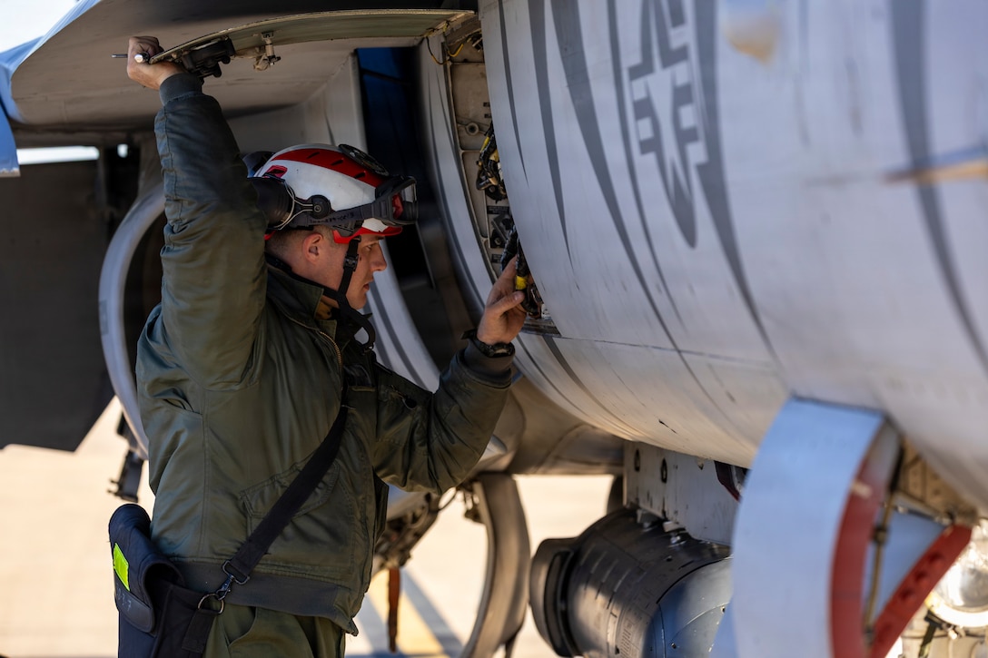 U.S. Marine Corps Lance Cpl. William Grigry, an aircraft ordnance technician with Marine Fighter Attack Squadron (VMFA) 112, Marine Aircraft Group 41, 4th Marine Aircraft Wing, conducts final checks on an F/A-18C Hornet aircraft in preparation for close air support training at Naval Air Station Joint Reserve Base Fort Worth, Texas, Dec. 9, 2025. The training serves to increase proficiency, validate ordinance handling procedures, and support joint fire support elements. (U.S. Marine Corps photo by Staff Sgt. Ethan M. LeBlanc)