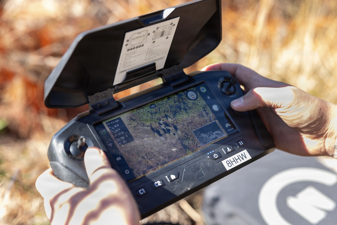 A U.S. Marine with Combat Logistics Battalion 24, Combat Logistics Regiment 27, 2nd Marine Logistics Group, surveys a checkpoint with a SkyDio X2 while conducting a tactical patrol as part of a battalion field exercise at Marine Corps Base Camp Lejeune, North Carolina, Dec. 9, 2025. Marines with CLB-24 conducted patrols and sUAS operations to sustain proficiency in training and readiness standards and establish baseline individual skills. (U.S. Marine Corps photo by Lance Cpl. Talan Werner)
