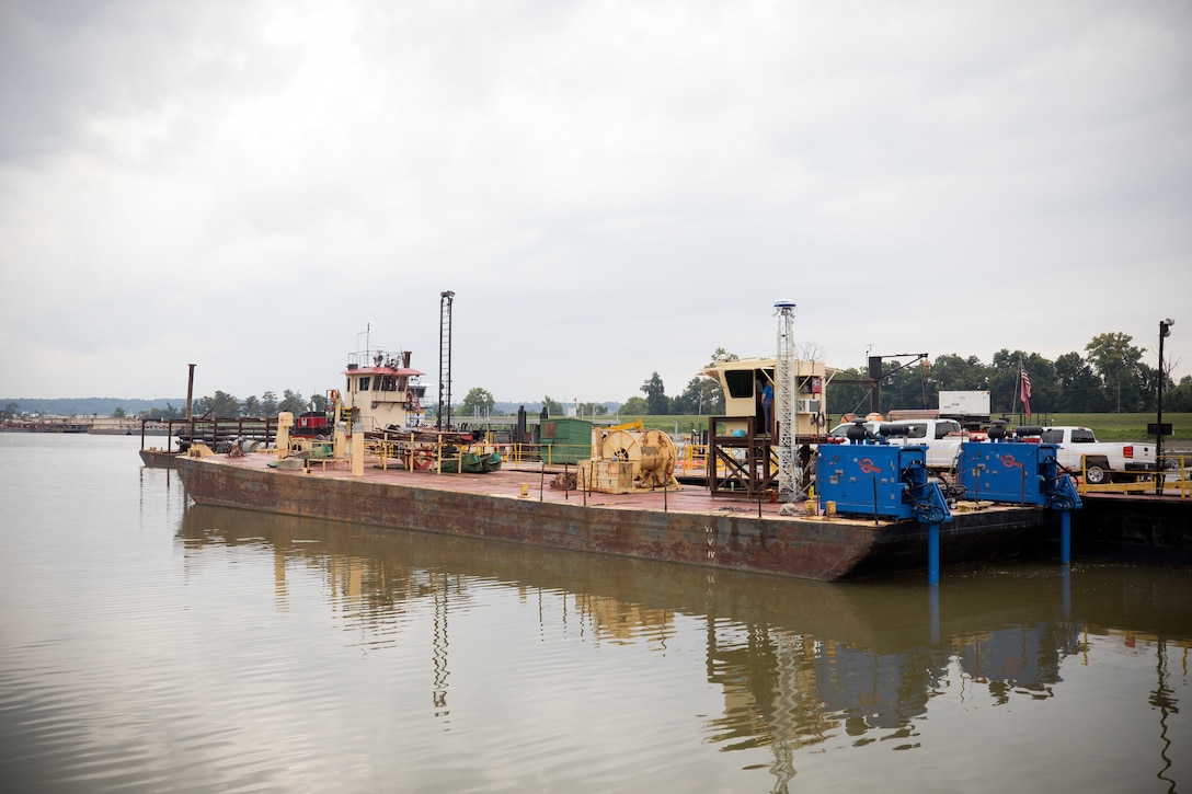 a modified barge docked in a harbor.