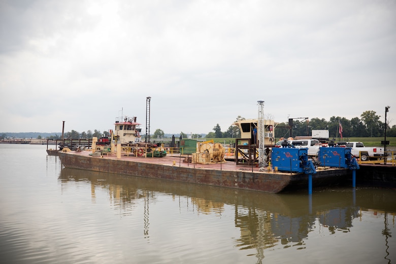 a modified barge docked in a harbor.