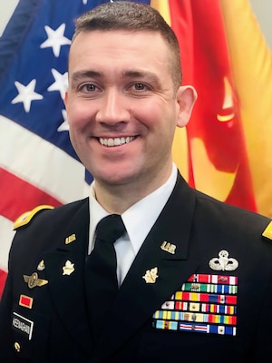 Colonel Daniel J. Keenaghan, commander 351st Civil Affairs Command, poses for his command photo in front of ceremonial flags.