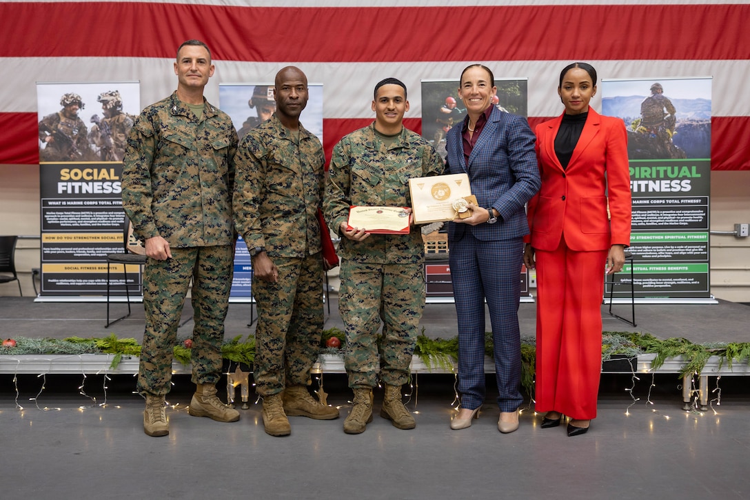 From left to right, U.S. Marine Corps Col. Fleming, commanding officer of Marine Aircraft Group 39, 3rd Marine Aircraft Wing, Sgt. Maj. Turay, sergeant major of MAG 39, 3rd MAW, Sgt. Rosario, aviation operation specialist, Col. Houser, the commanding officer of Marine Corps Air Station Camp Pendleton, Sgt. Maj. Smith-Leavey, sergeant major of MCAS Camp Pendleton, stand for a photo at the 9th annual Joint Leadership Education Conference at MCAS Camp Pendleton, California, Dec. 10, 2025. The conference is a two-day event featuring panels and presentations on leadership, personal readiness, professional development, and strategic growth. The conference also included an awards ceremony, a series of focused discussions ranging from trauma informed leadership and relationship dynamics to financial readiness, tuition assistance, and health fundamentals. (U.S Marine Corps photo by Lance Cpl.  Estrada)