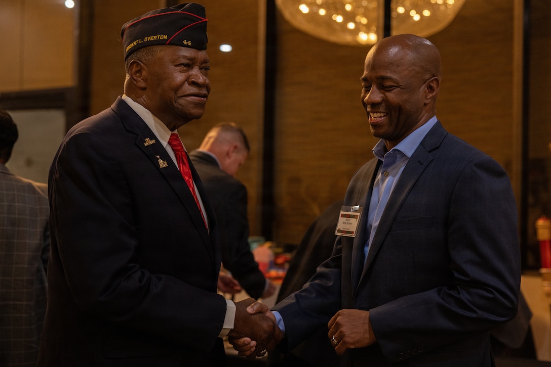 U.S. Marine Corps Brig. Brown, right, the commanding general of Marine Corps Installations West, greets a guest during the 2025 Holiday Buffet and Cocktail Reception at Marine Corps Base Camp Pendleton, California, Dec. 11, 2025. Brig. Gen. Brown hosted the event to kick off the holiday season and build camaraderie between MCIWEST and its surrounding units and organizations. (U.S. Marine Corps photo by Cpl.  Akamelu)