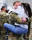 Sydney Weaver jumps into the arms of her husband, Illinois Army National Guard Staff Sgt. Justin Weaver, upon his return from deployment.