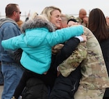 Ariel Short, along with daughters, Kinley, age 7, Keller, age 5, and Charley, age 3, welcome home 1st Sgt. Dylan Short, 2nd Battalion, 130th Infantry Regiment, during the battalion’s homecoming event at MidAmerica St Louis Airport in Mascoutah, Dec. 12.