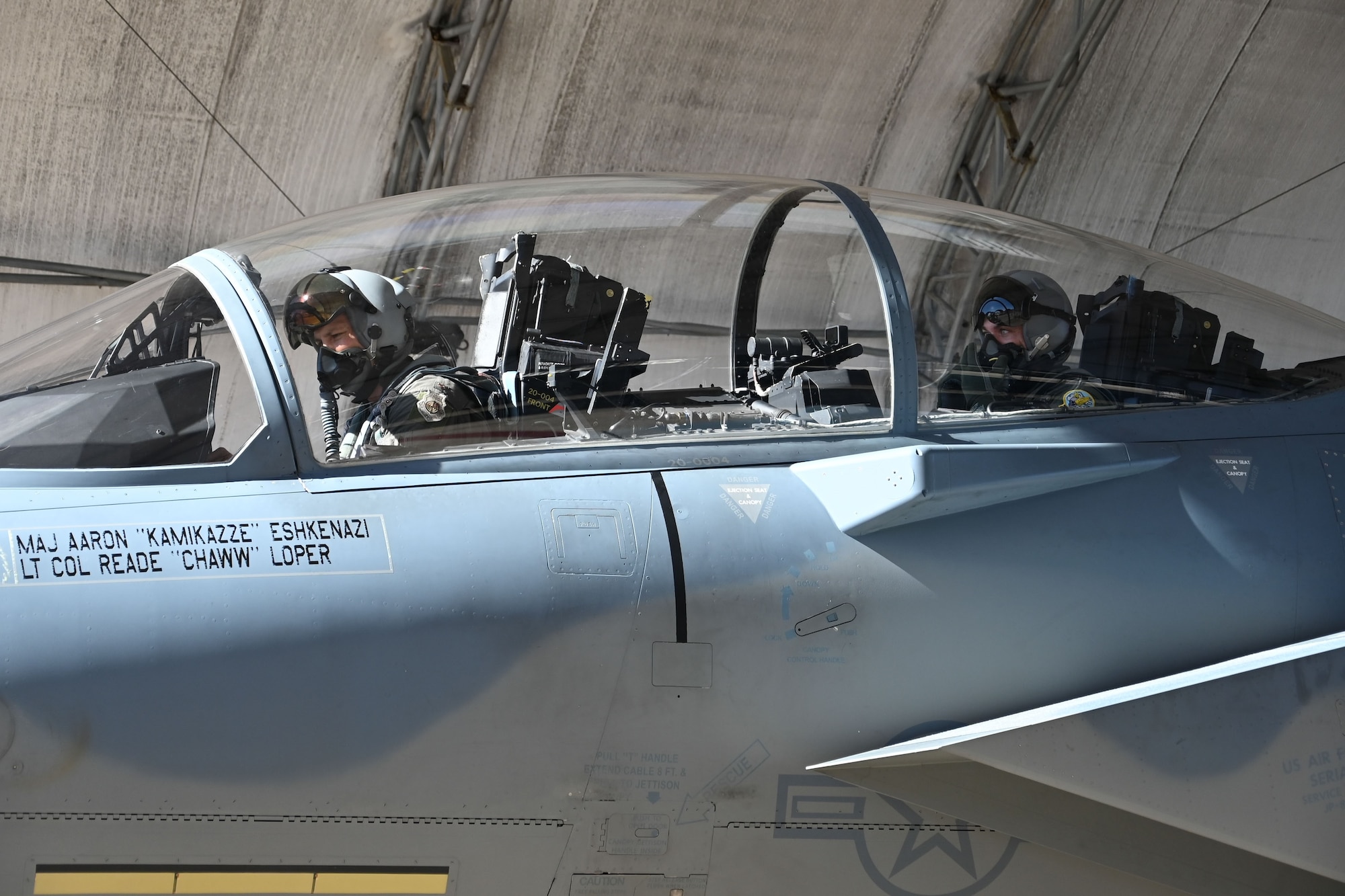 U.S. Air Force Maj. Aaron Eshkenazi, F-15EX Test Director for the 84th Test and Evaluation Squadron, performs preflight procedures for the F-15EX with Under Secretary of the Air Force Matt Lohmeier, at Eglin Air Force Base, Florida, December 11, 2025. During his visit, Lohmeier gained valuable insights from the 84th TES and 85th TES to help inform future decisions regarding the platform. The future F-15 fleet will complement 5th generation aircraft, bringing substantial additional capacity for over-sized long-range fires, sensors, and electronic warfare capabilities to defend critical locations in highly contested areas. (U.S. Air Force photo by Capt. M. Ryan Goss)