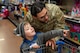 A U.S. Air Force Defender assigned to Minot Air Force Base helps a child pick out toys during the annual Cops and Kids event at Walmart in Minot, North Dakota, Dec. 14, 2025. Service members volunteered their time to assist children while they shopped for holiday gifts as part of a community outreach event. (U.S. Air Force photo by Senior Airman Luis Gomez)