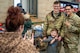 U.S. Air Force Defenders assigned to Minot Air Force Base pose for a photo with a child during the annual Cops and Kids event at a Walmart in Minot, North Dakota, Dec. 14, 2025. The event brought together military members, law enforcement and families to support children in the local community during the holiday season. (U.S. Air Force photo by Senior Airman Luis Gomez)
