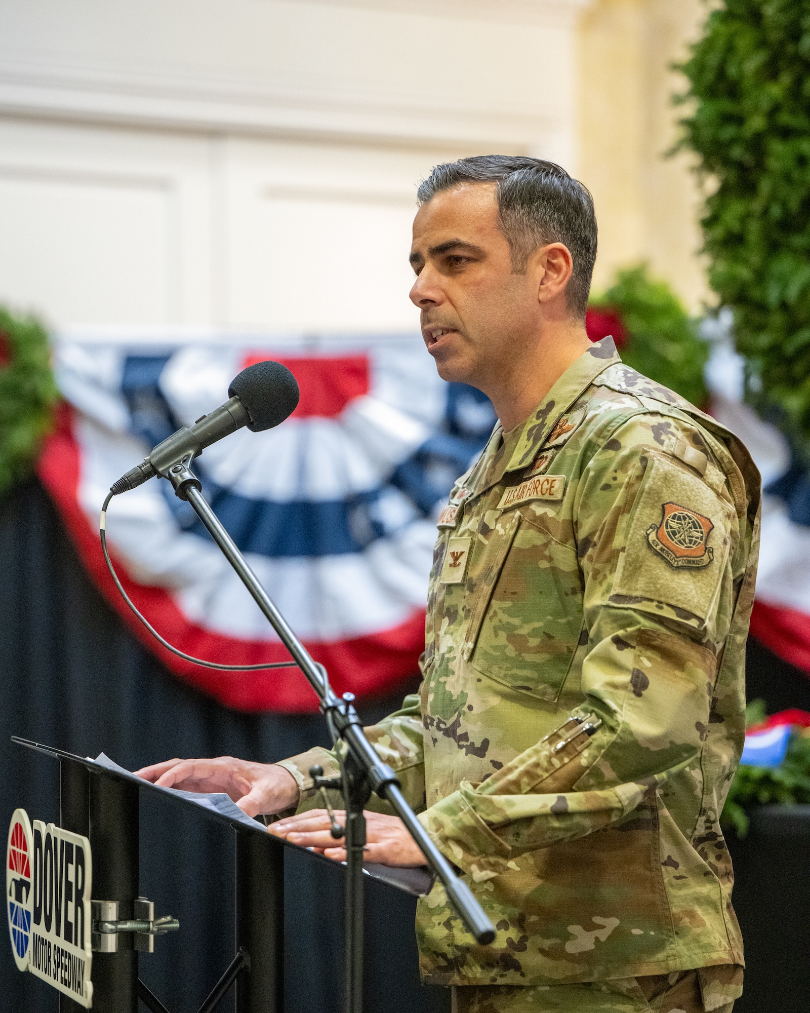 U.S. Air Force Col. Jamil Musa, 436th Airlift Wing commander, gives remarks during a Wreaths Across America event in Dover, Delaware, Dec. 11, 2025. Musa and other unit commanders from Dover Air Force Base were presented holiday wreaths during the ceremony. (U.S. Air Force photo by Mauricio Campino)