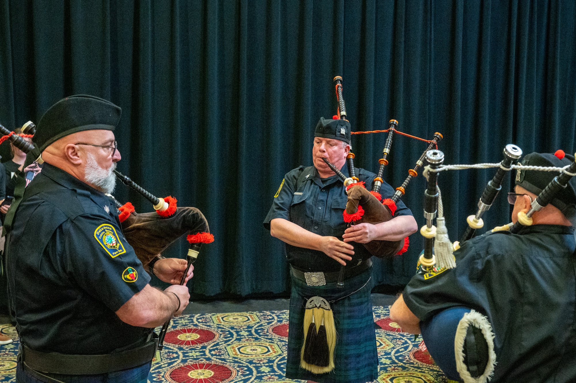 Members of the Delaware Celtic Society Pipe Band play Amazing Grace during a Wreaths Across America event in Dover, Delaware, Dec. 11, 2025. Morrill Worcester began laying holiday wreaths at Arlington National Cemetery in 1992 and has continued the annual tradition since then. (U.S. Air Force photo by Mauricio Campino)