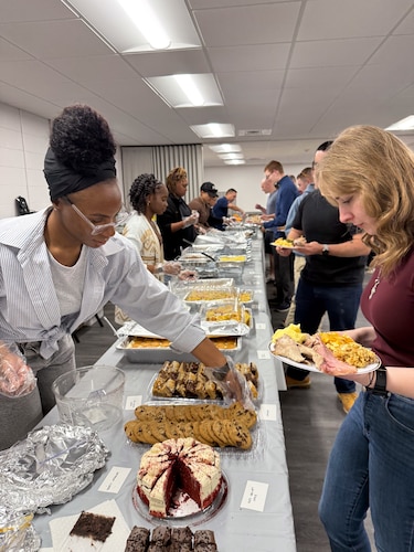 Airmen observe different desserts available at the chapel’s Kitchen on Maxwell Air Force Base, Alabama, Nov. 27, 2025.