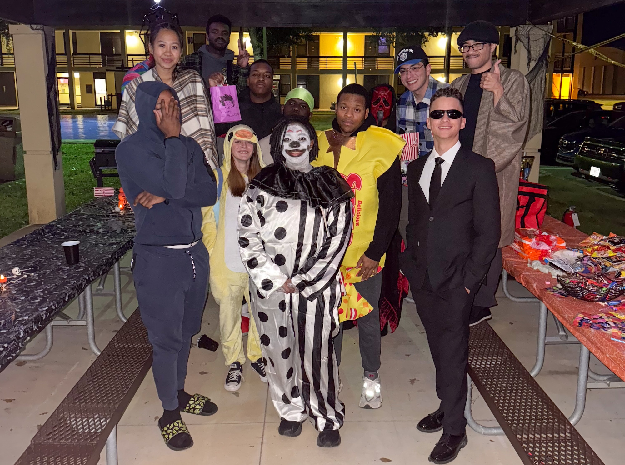 Airman 1st Class Alexia Lassin (middle front), poses for a photo with Airmen at the dorms on Maxwell Air Force Base, Alabama, Oct. 31, 2025.