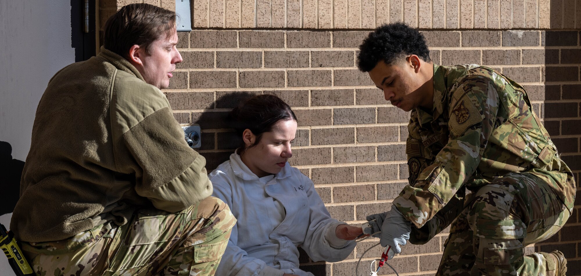 Members of the 22nd Air Refueling Wing provide immediate care to a simulated casualty during a fuel cell extraction exercise.