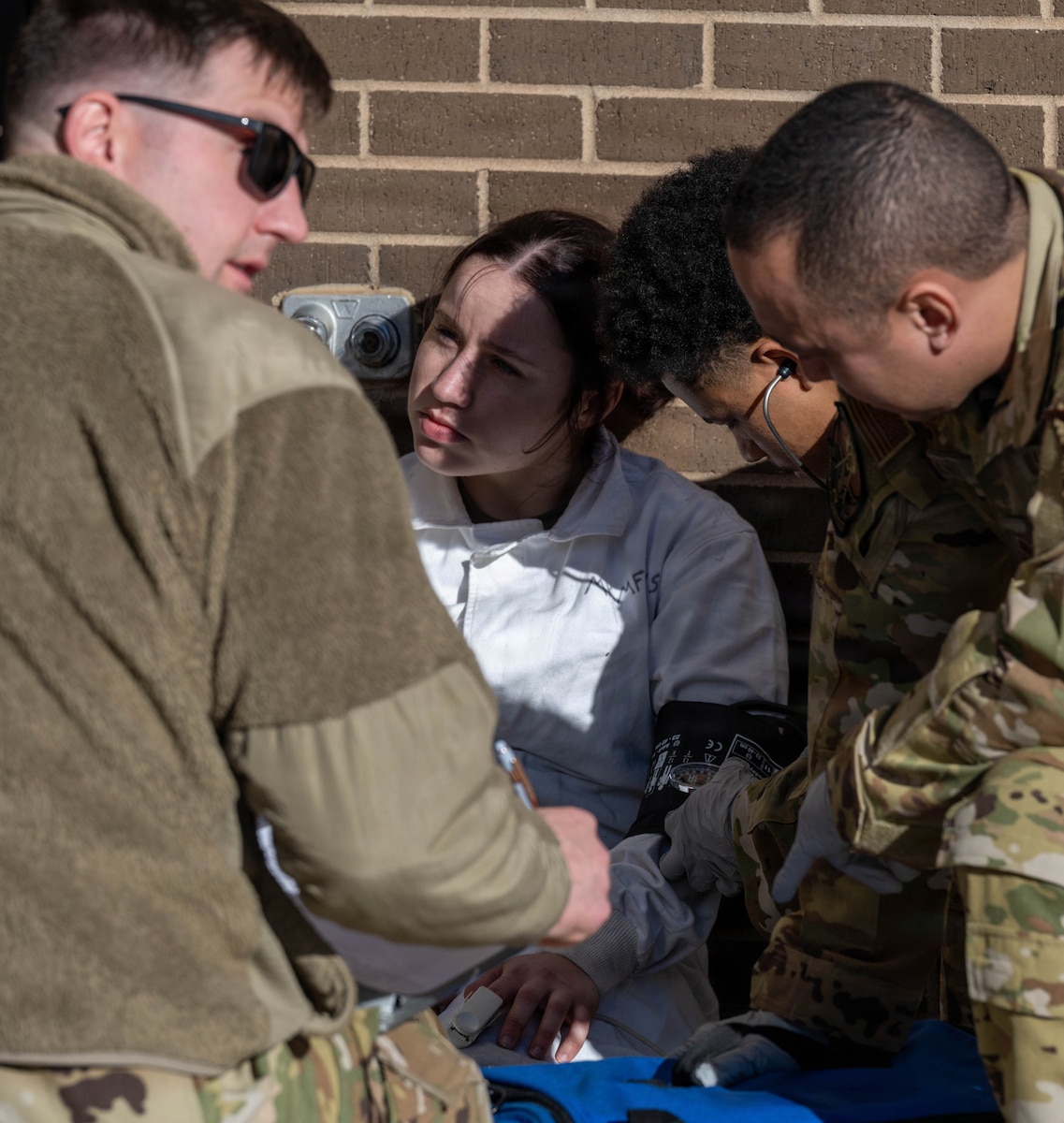 22nd Air Refueling Wing Airmen conduct a thorough medical assessment on a simulated casualty after a successful fuel cell extraction.
