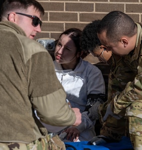 22nd Air Refueling Wing Airmen conduct a thorough medical assessment on a simulated casualty after a successful fuel cell extraction.