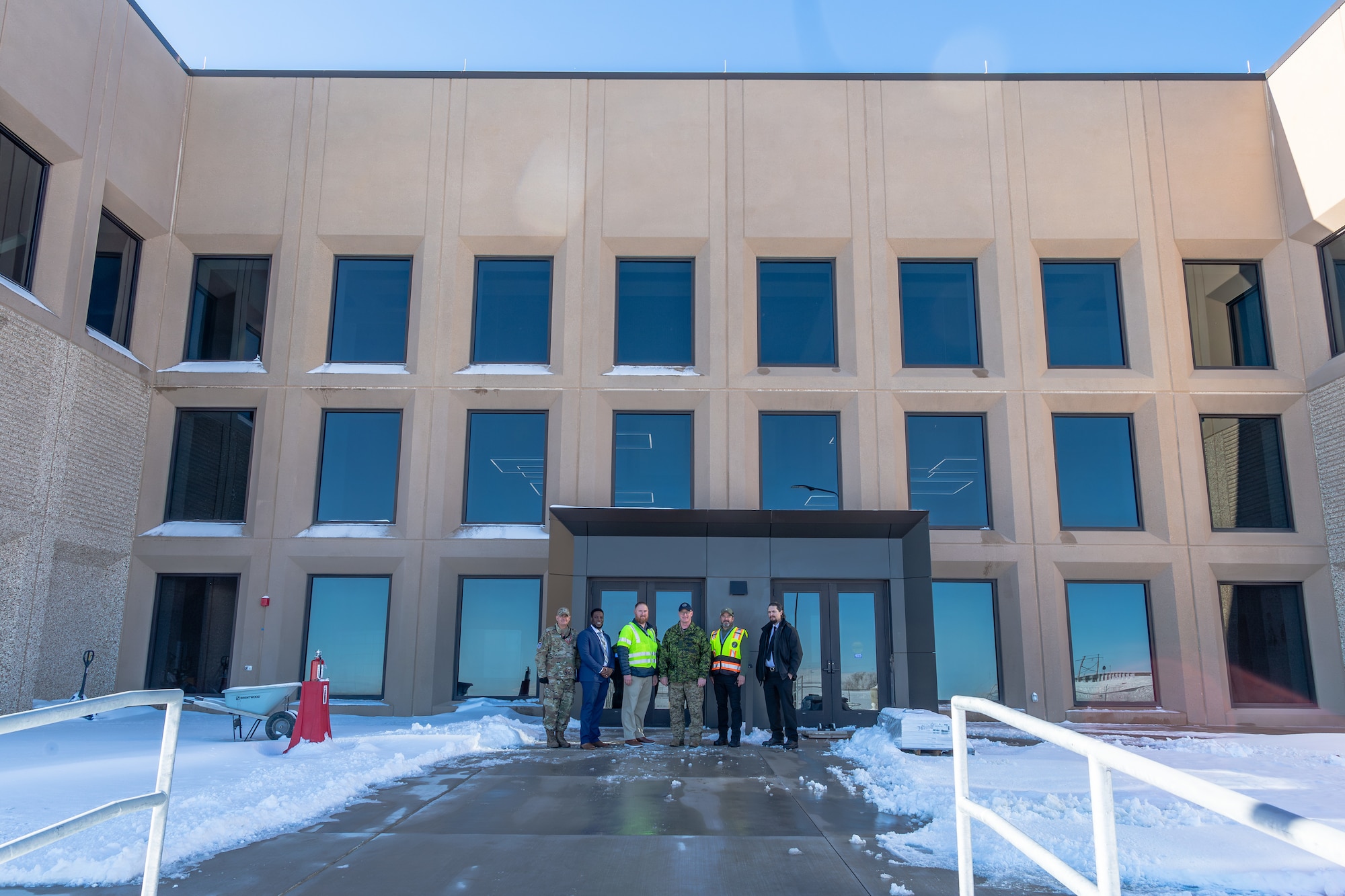 Men stand in front of a building