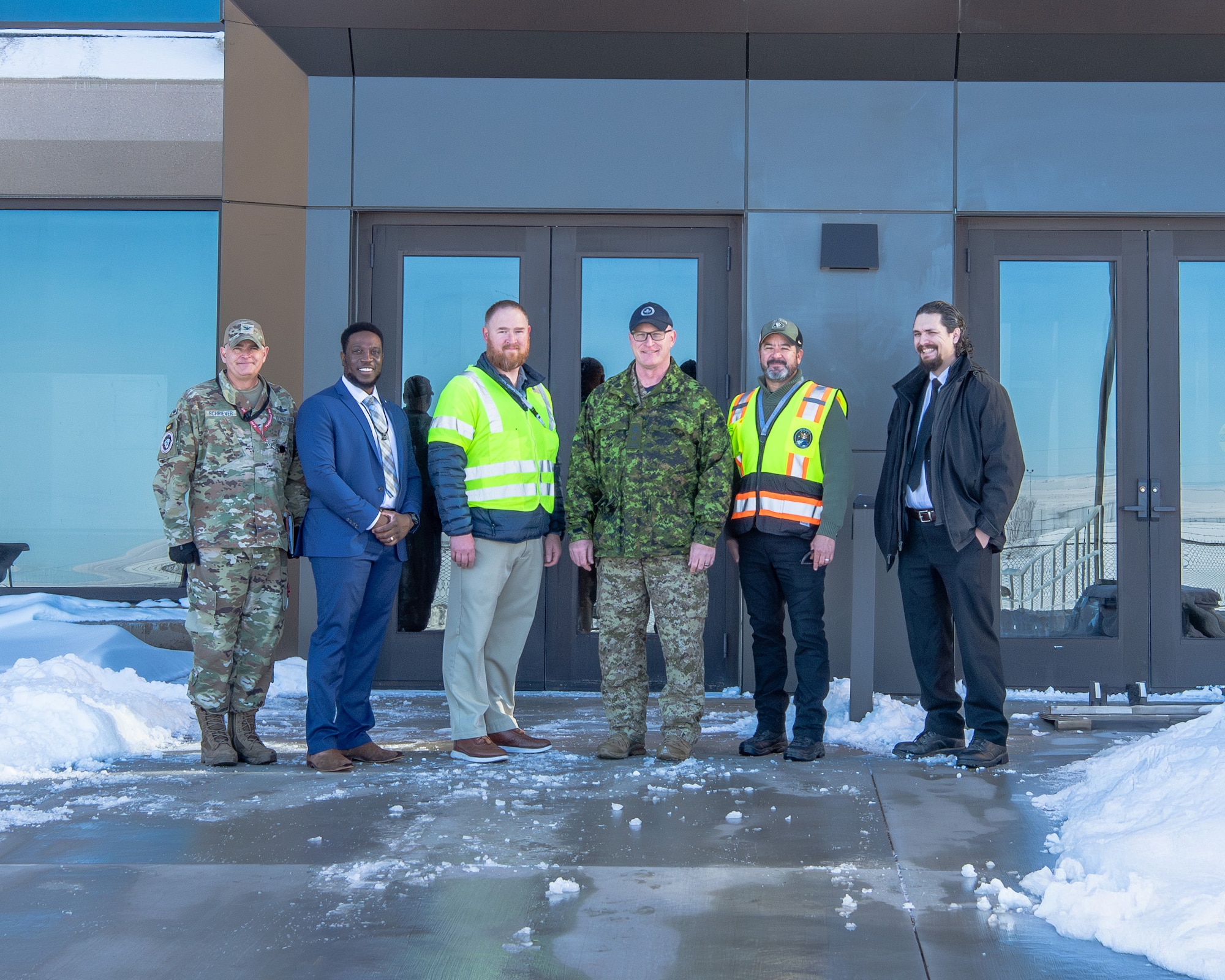 Men stand in front of a building