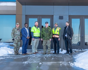 Men stand in front of a building