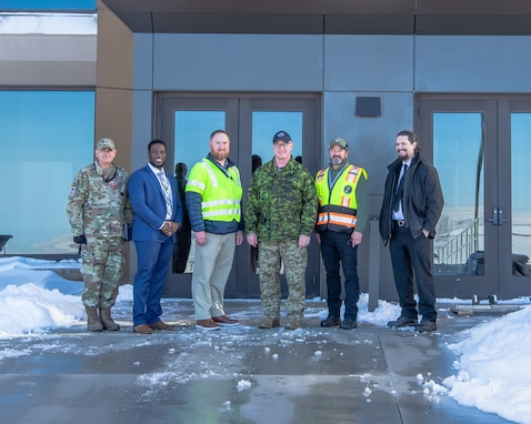 Men stand in front of a building