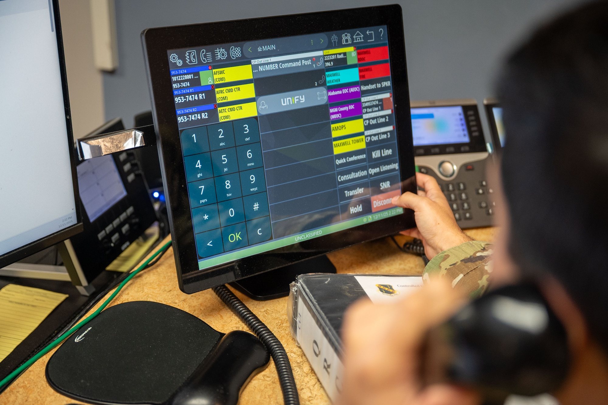U.S. Air Force Senior Airman Noah Roubicek, 42d Wing Staff Agency Command Post emergency actions controller, makes a test call on the UNIFY telephone system at Maxwell Air Force Base, Alabama, Dec. 12, 2025.