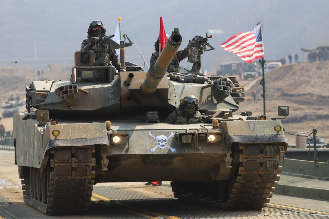 Republic of Korea army soldiers assigned to 5th Engineer Brigade, pull security on the K1 tank while it moves across M3 bridge vehicle as part of Freedom Shield 25/Combined Wet Gap Crossing training March 20, 2025 in South Korea.