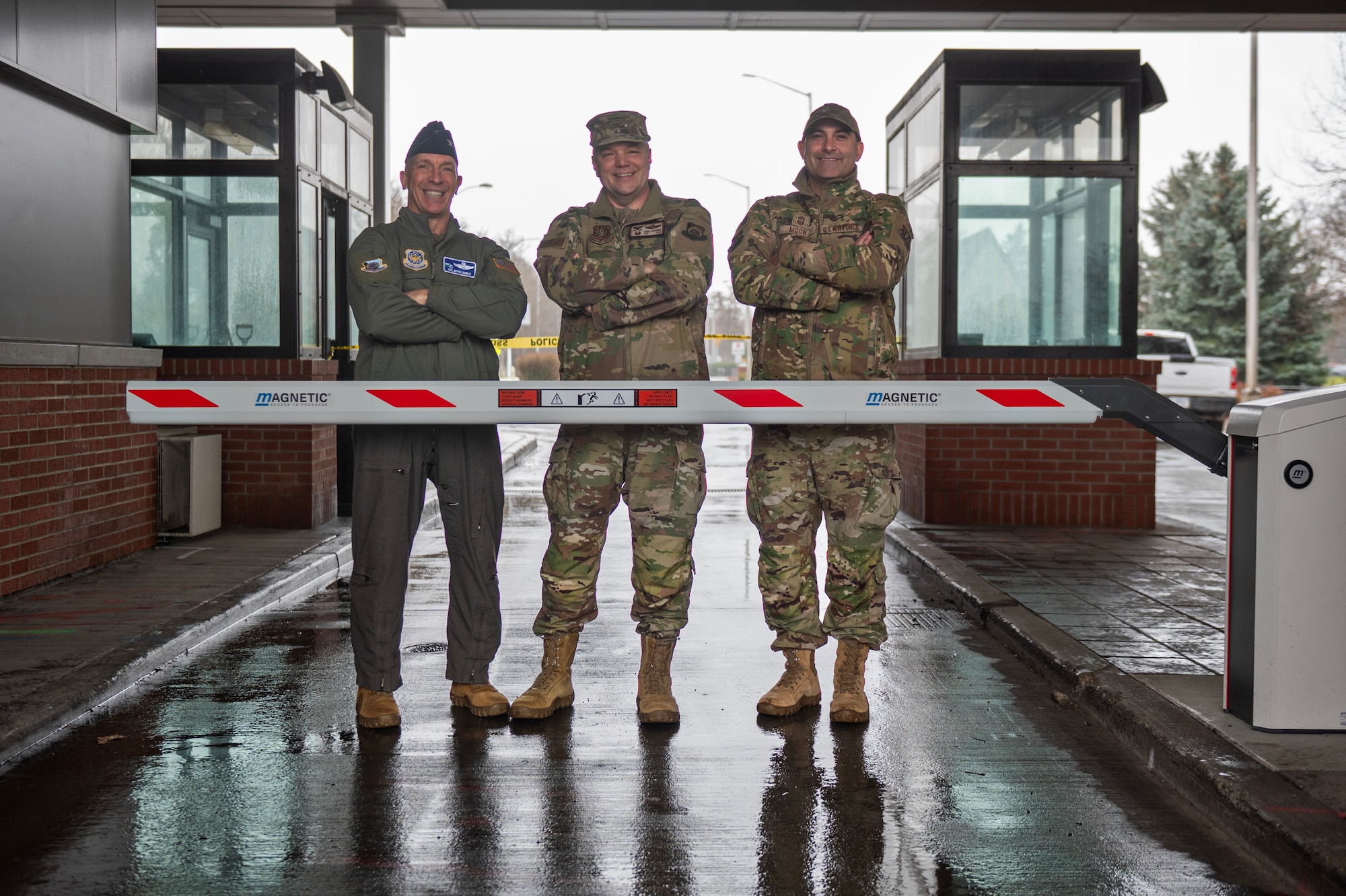 From left, U.S. Air Force Col. Bryce Dibble, 92nd Air Refueling Wing deputy commander, Col. Chad Cisewski, 92nd Air Refueling Wing commander and Chief Master Sgt. Lindsay Moon, 92nd Air Refueling Wing command chief, stand behind the automatic gate of the newly installed Fast Pass System at Fairchild Air Force Base, Washington, Dec. 15, 2025. The Fast Pass System is designed to automate portions of the entry process, allowing a smoother and more continuous flow of traffic. (U.S. Air Force photo by Senior Airman Morgan St Marks)