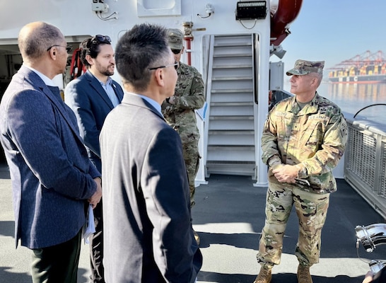 Brig. Gen. John Lloyd, U.S. Army Corps of Engineers South Pacific Division commander, right, speaks with leaders and subject-matter experts with the Port of Long Beach and USACE during a boat tour of the port Dec. 2 in Long Beach, California.