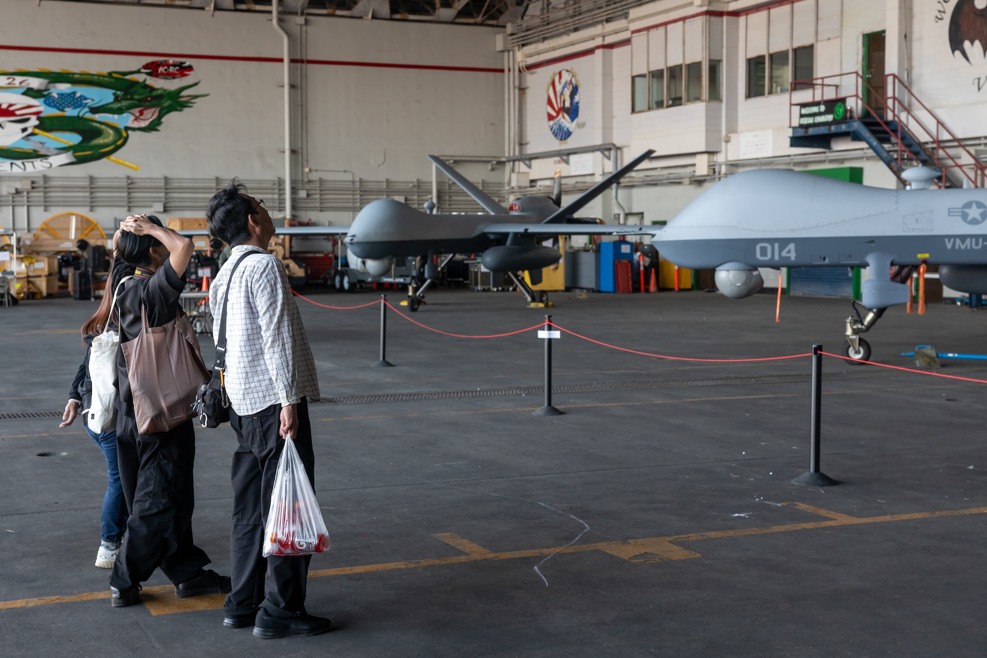 Attendees of America Fest 2025 tour a static display of a U.S. Marine Corps MQ-9A MUX/MALE unmanned aircraft with Marine Unmanned Aerial Vehicle Squadron 3, Marine Aircraft Group 24, 1st Marine Aircraft Wing on Kadena Air Base, Okinawa, Japan, March 22, 2025.