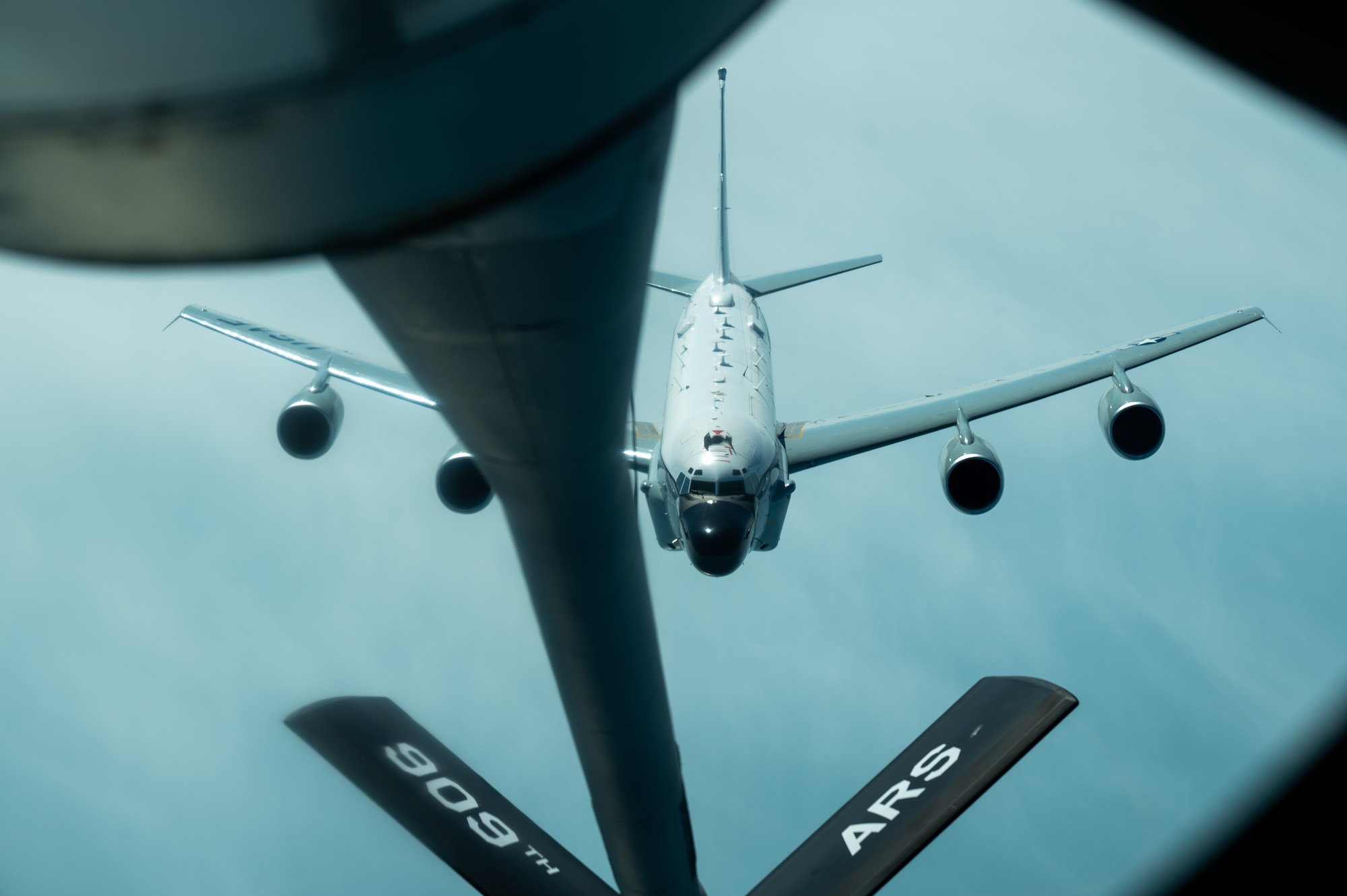 A U.S. Air Force RC-135 Rivet Joint assigned to the 82nd Reconnaissance Squadron approaches a KC-135 Stratotanker assigned to the 909th Air Refueling Squadron to receive aerial refueling over the Pacific Ocean, March 31, 2025.