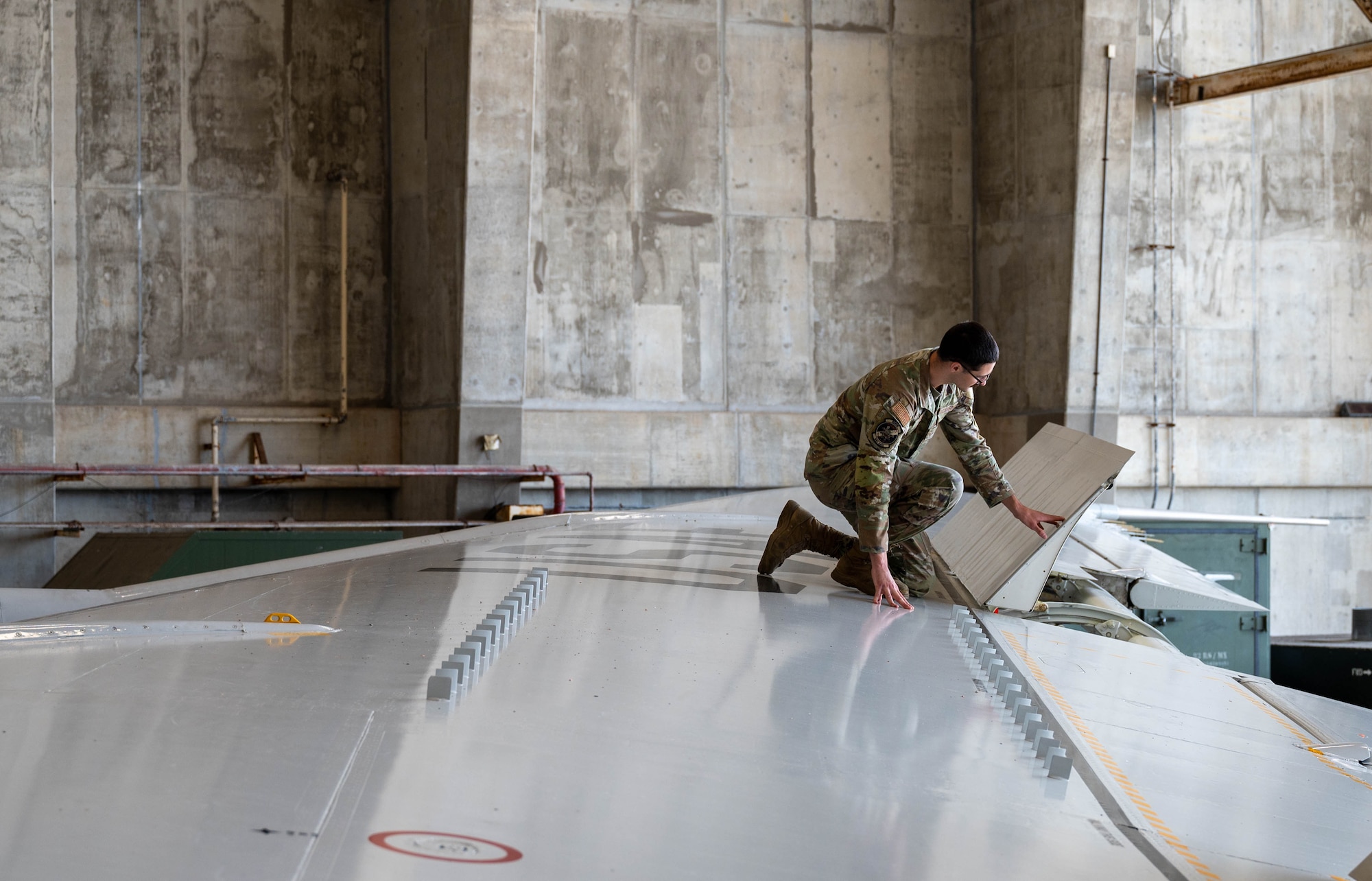 U.S. Air Force Senior Airman Joseph Aurora, 718th Aircraft Maintenance Squadron, 961st Aircraft Maintenance Unit, command, control, computers, communication, intelligence, surveillance and reconnaissance journeyman, conducts a routine inspection on an E-3 Sentry at Kadena Air Base, Japan, April 9, 2025.