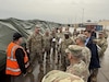 Army Maj. Gen. Eric Shirley, U.S. Army Sustainment Command’s commanding general, and Command Sgt. Maj. Jason Gusman, ASC’s senior enlisted advisor, speak to members from Army Field Support Battalion-Germany and the 405th Army Field Support Brigade at the Coleman Army Prepositioned Stocks-2 worksite In Mannheim, Germany, during their site visit to Europe, Dec. 9-12, 2025. (U.S. Army courtesy photo)